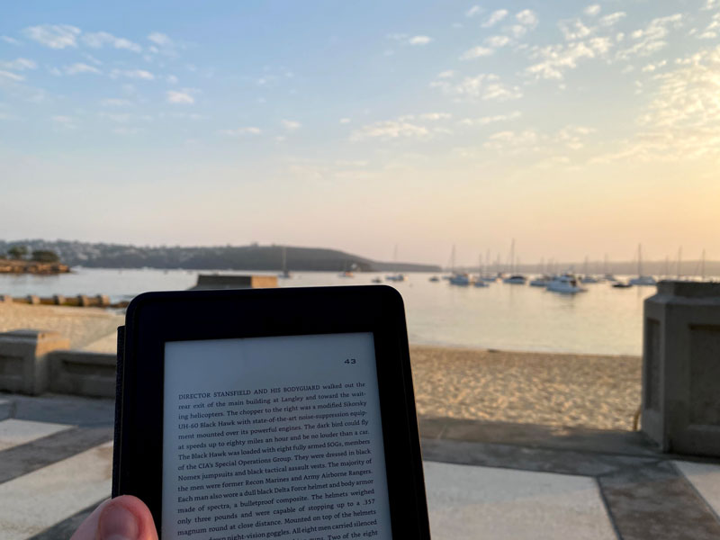Reading my Kindle by the water